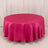 Round pink tablecloth on a plain backdrop.
