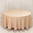 Round beige tablecloth draped over a circular table.