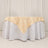 Elegant beige tablecloth draped over a round white table.