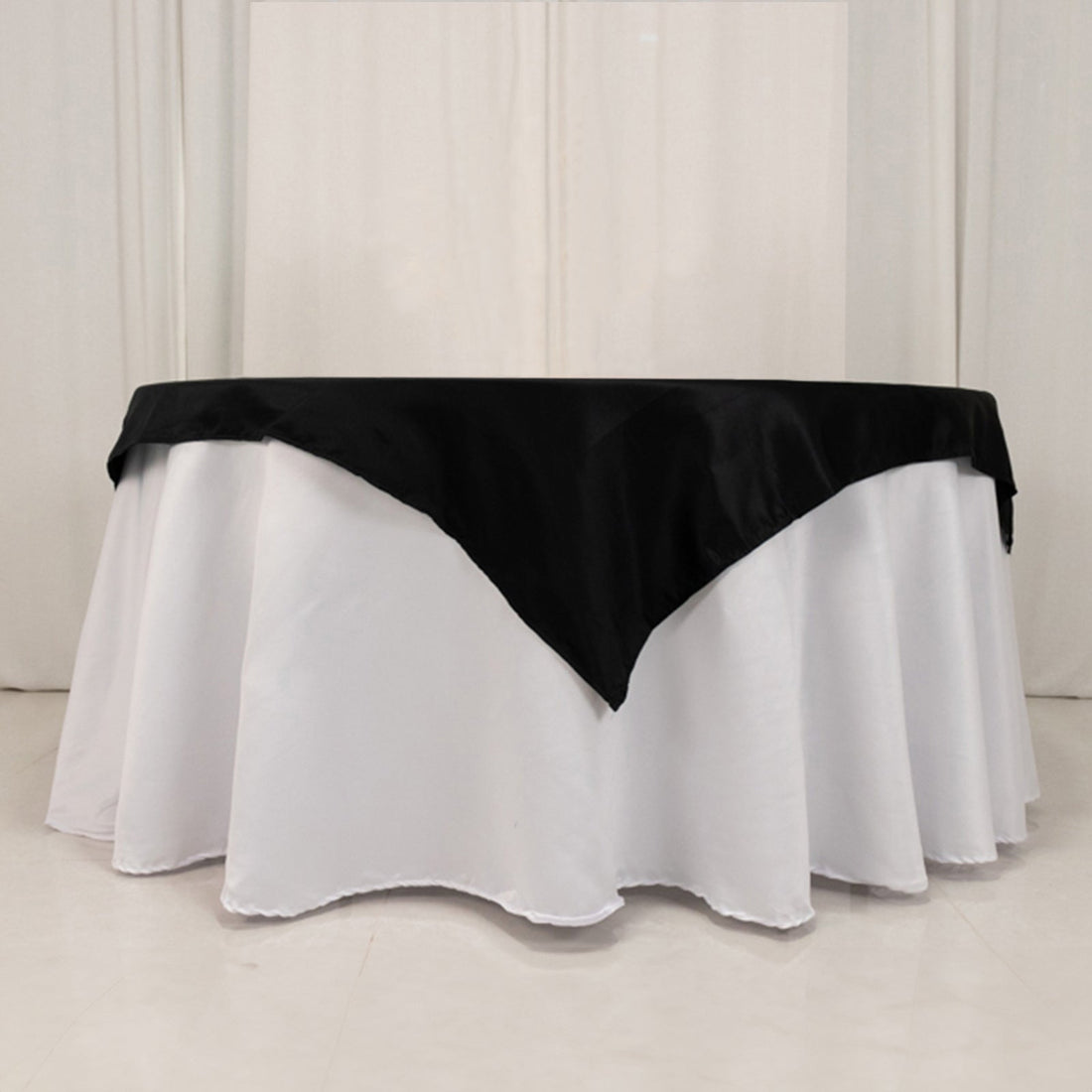 Black and white tablecloth with elegant draping for events and dining.
