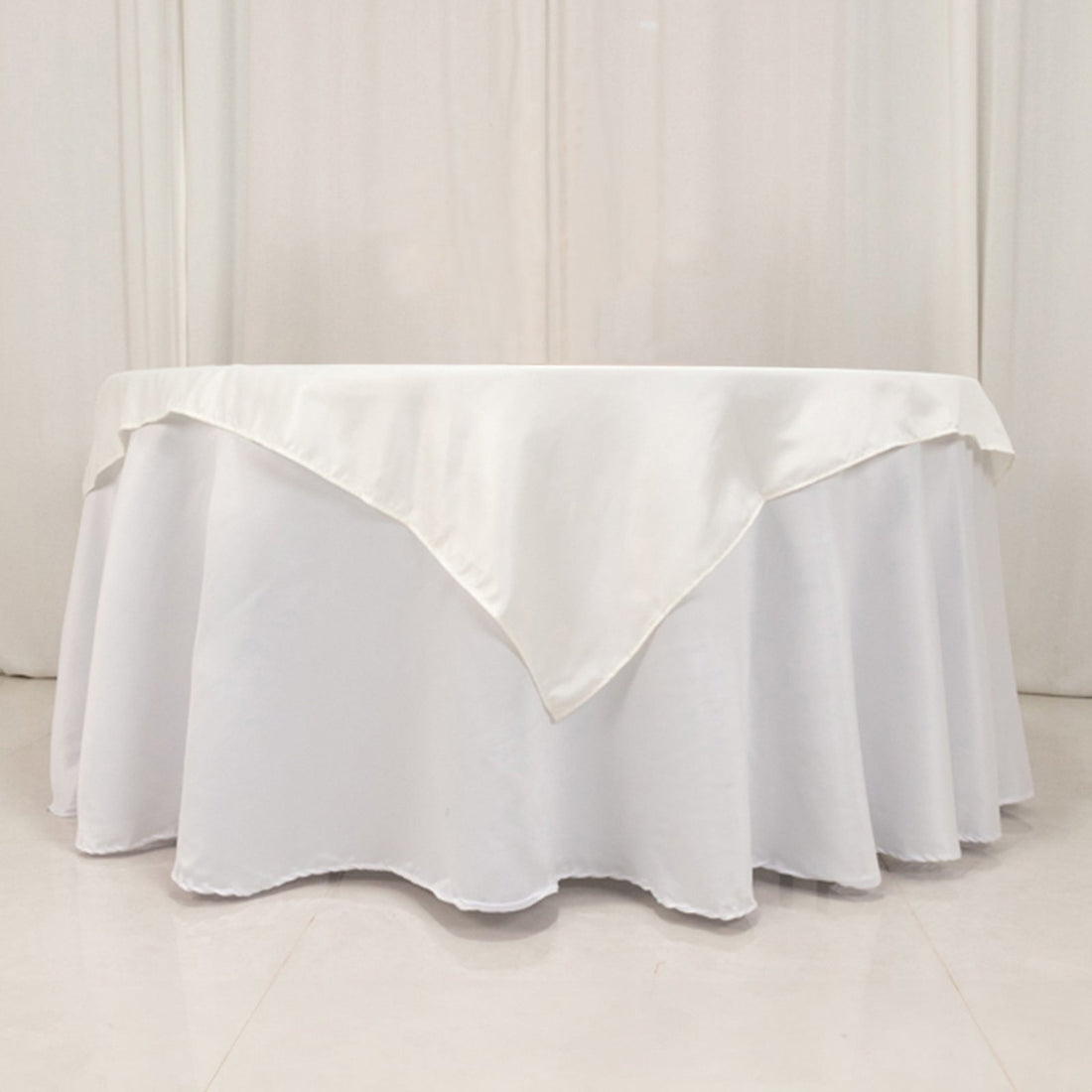 White tablecloth with elegant draping and satin finish