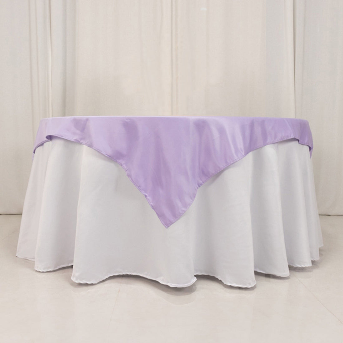 Lavender tablecloth draped elegantly over a round white table