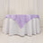 Lavender tablecloth draped elegantly over a round white table