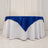 Blue satin tablecloth on a round white table.