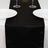 Elegant black satin table runner with white plates and wine glasses.