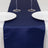 Navy satin table runner with two white plates and glasses