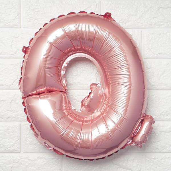 Rose gold number 0 balloon on a textured white background