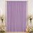 Lavender curtain backdrop with white roses and candles for elegant event decor
