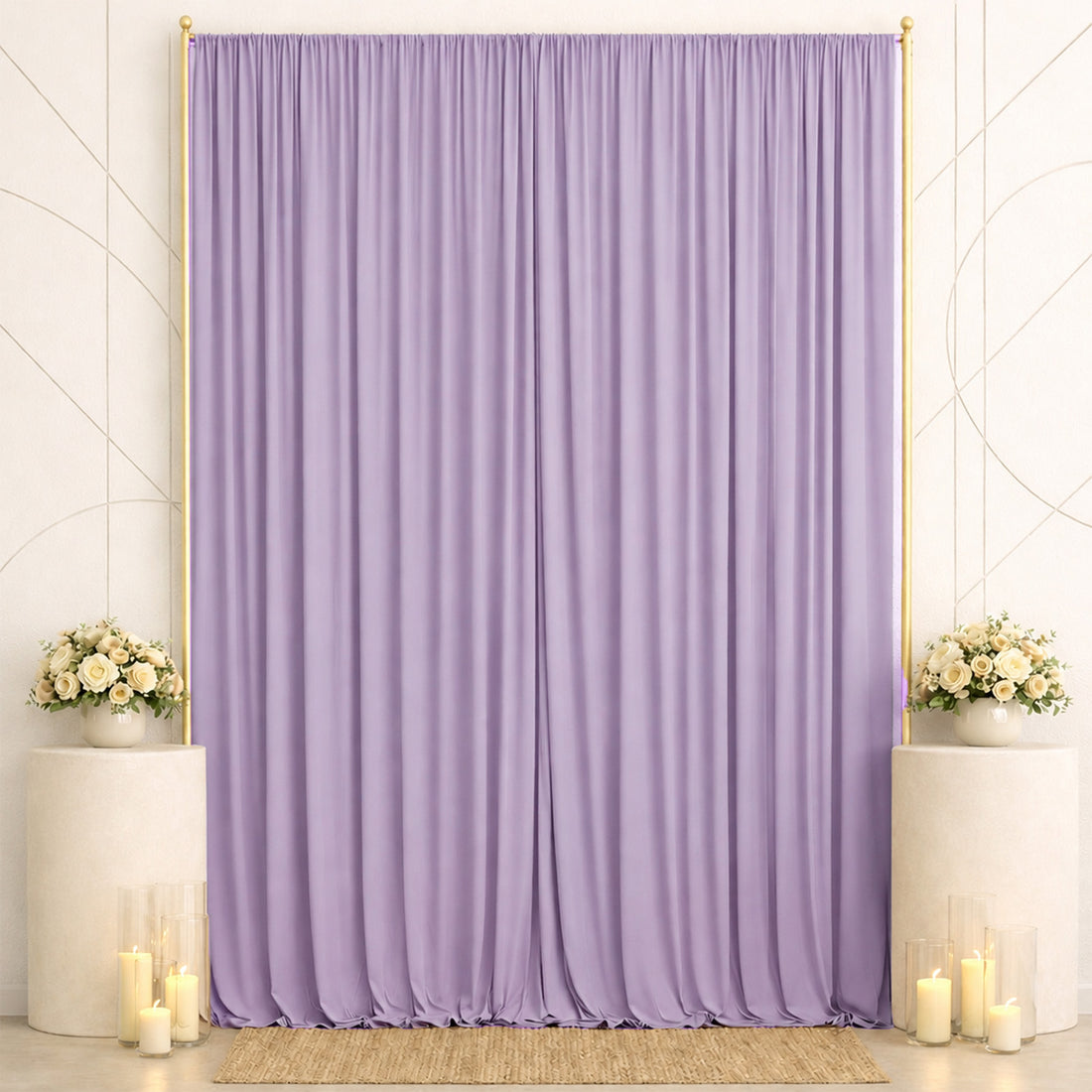 Lavender draped backdrop with floral arrangements and candles for elegant event decor