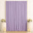 Lavender draped backdrop with floral arrangements and candles for elegant event decor