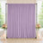 Lavender draped wedding backdrop with floral arrangements and candles