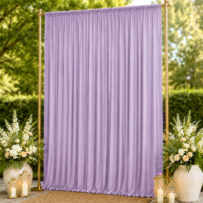 Lavender draped wedding backdrop with gold stand and floral lantern decor