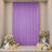 Lavender event backdrop with floral arrangements and pastel balloons