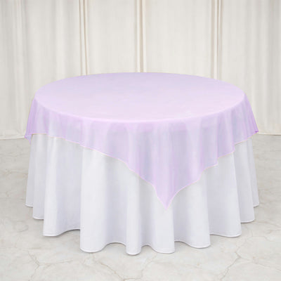 Lavender round tablecloth with white satin underlay on banquet table