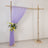 Wooden wedding arch with lavender drapery and floral arrangement.