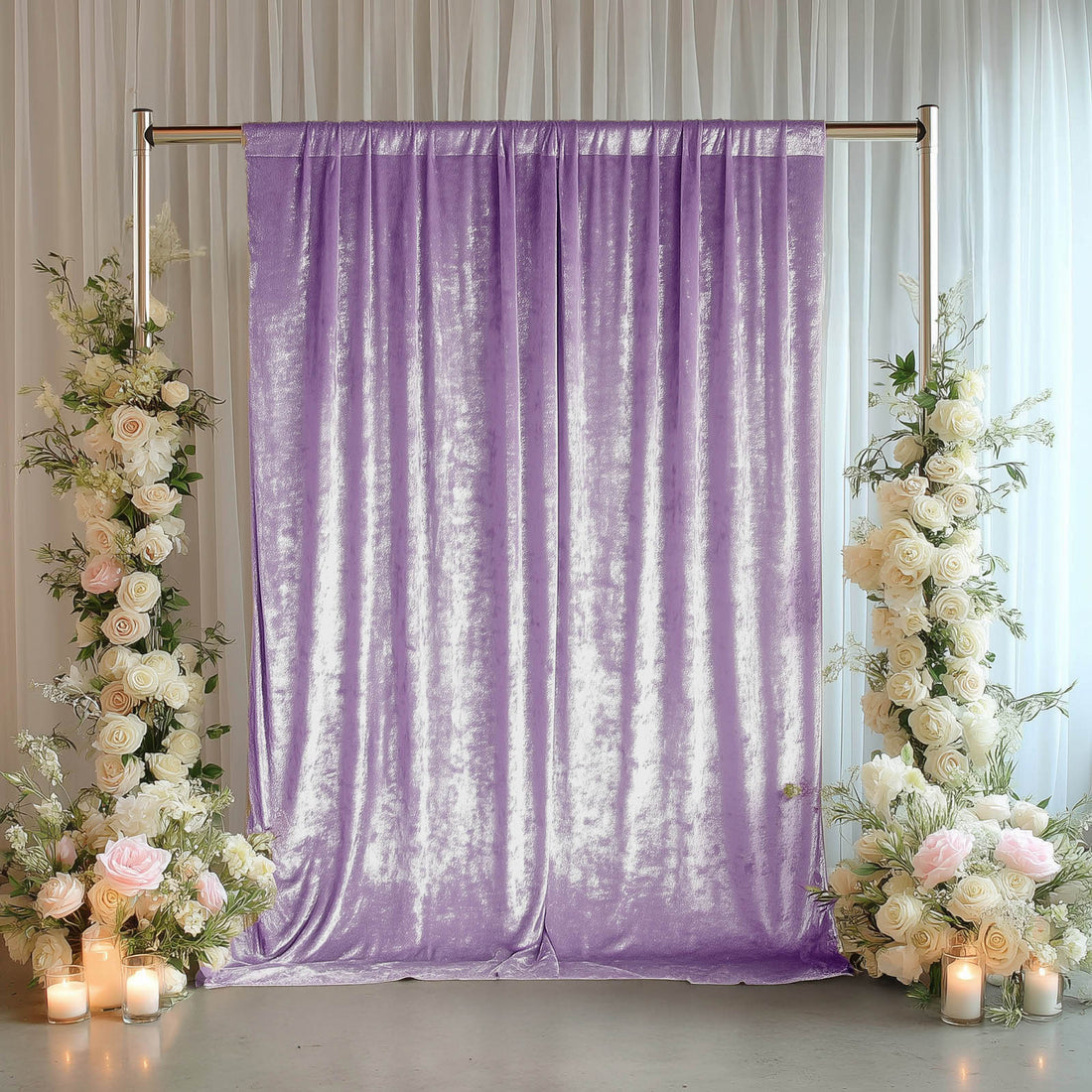 Lavender shimmer wedding backdrop with floral arrangements and candles