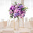 Lavender and purple floral centerpiece in an elegant dining setting.
