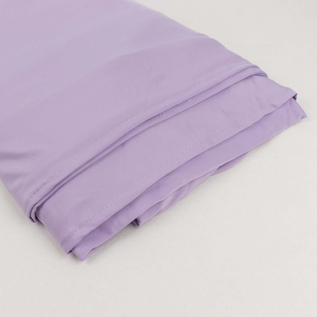Folded lavender pillowcase on a plain background.