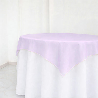Lavender tablecloth on round table in bright white room