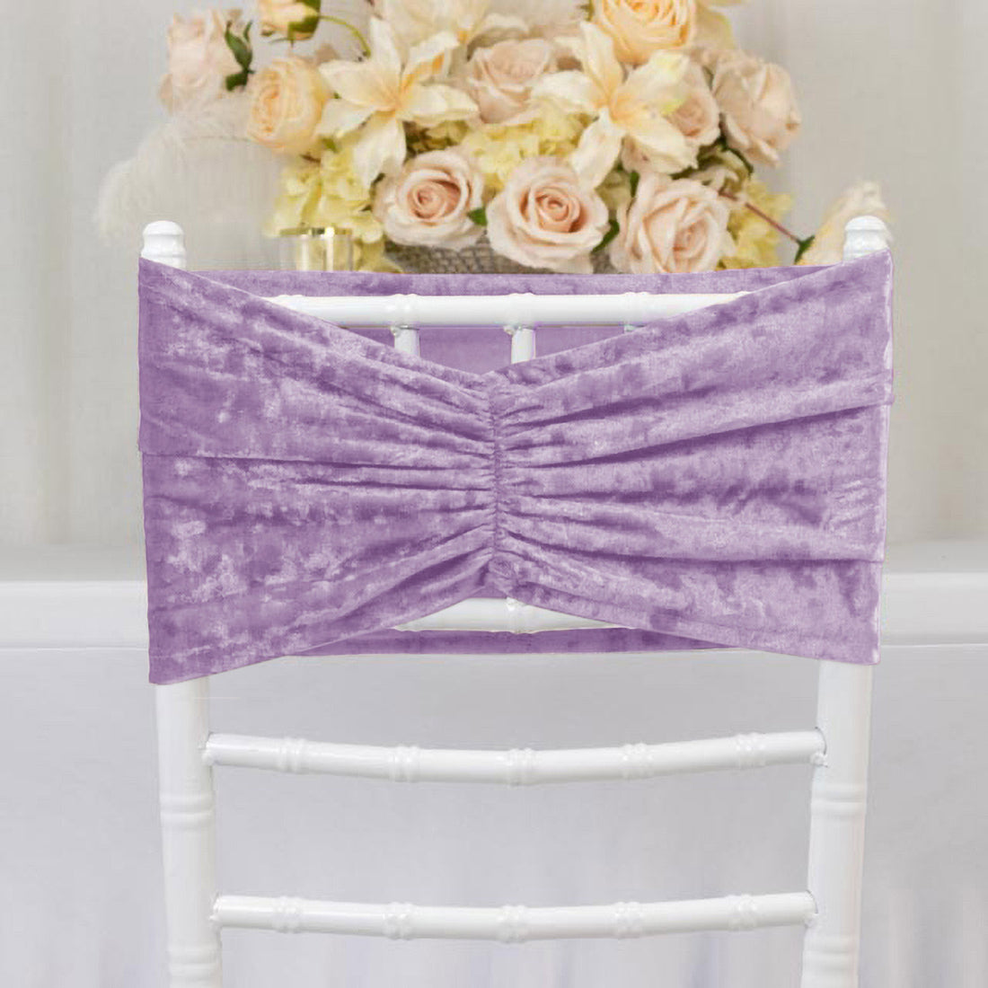 Lavender velvet chair sash on white chair with floral wedding backdrop