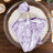 Lavender velvet napkin folded on elegant charger plate for table setting