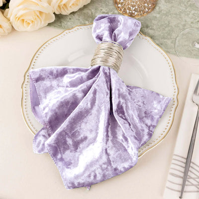 Lavender velvet napkin with silver ring on elegant dinner plate