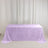 Lavender velvet tablecloth draped over a rectangular table against white curtains
