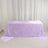Lavender velvet tablecloth draped over banquet table against white curtains