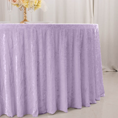 Lavender velvet tablecloth on round event table with floral centerpiece
