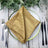 Elegant gold napkin elegantly folded on a decorative plate. #whtbkgd