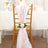 Decorative chair sash with pink petals and a rose for event styling.