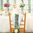 Decorated chair with floral accents at a wedding reception table.