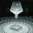 Crystal lamp casting intricate light patterns on a dark surface.