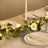 Elegant table setting with floral centerpiece, candles, and crystal glassware.