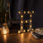 Illuminated vintage marquee letter "H" on a stylish table setting.