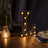 Illuminated vintage letter "L" marquee sign on a wooden table.