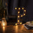 Illuminated vintage marquee letter "P" on a wooden table.