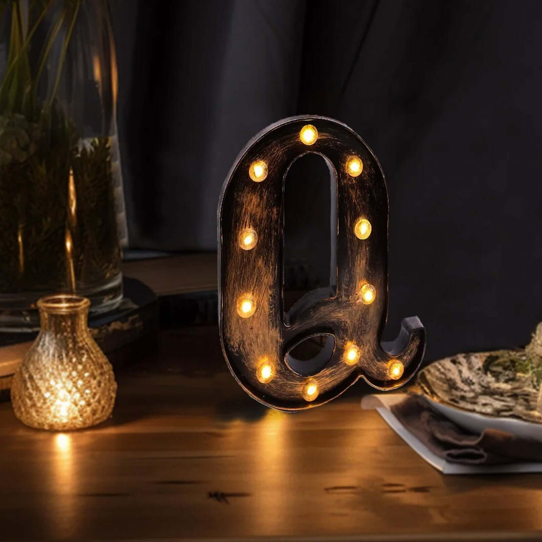 Decorative light-up letter "Q" with vintage bulb design, perfect for home decor.