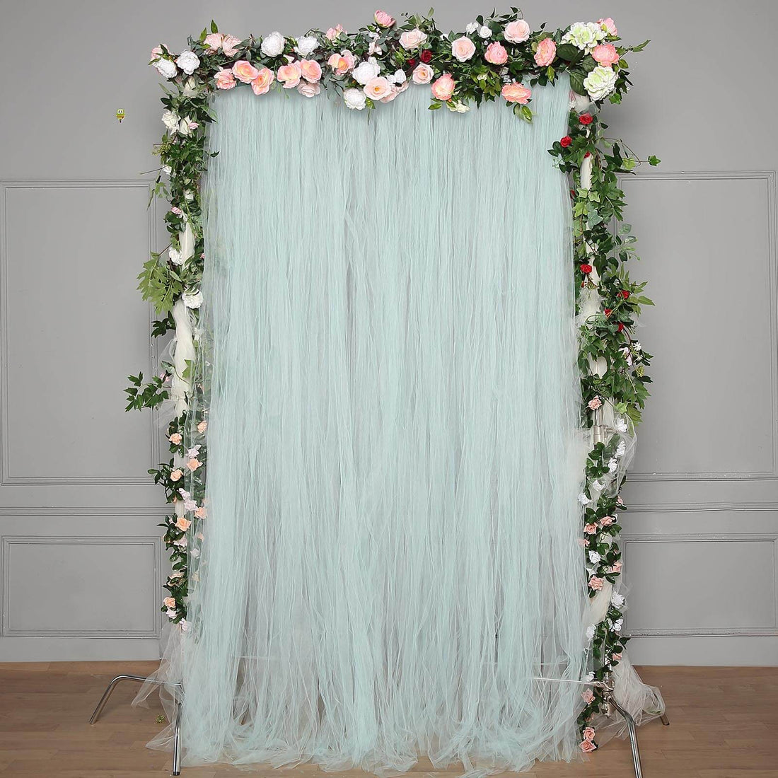 Floral backdrop curtain with mint tulle and roses for events and photography.