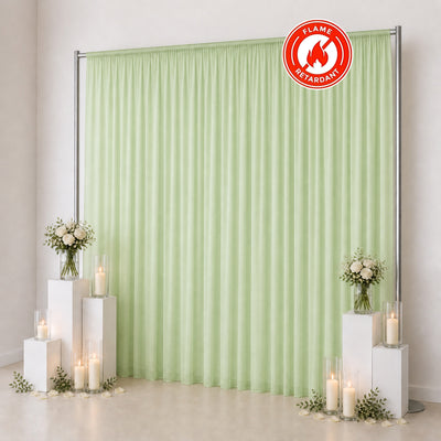 Light green flame retardant curtain backdrop with floral candles and pedestal decor