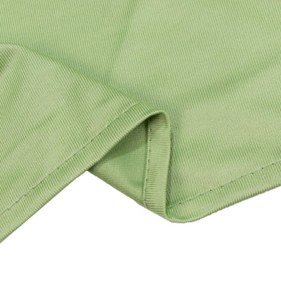 Light green ribbed fabric texture close-up with folded edge