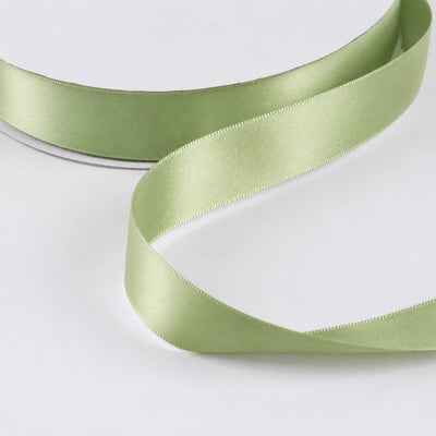 Light green satin ribbon roll on white backgrounds