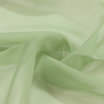 Light green sheer fabric with soft flowing folds and delicate texture#whtbkgd