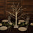Decorative lighted birch tree centerpiece for dining table setting.