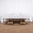 White tablecloth draped over a wooden table with dining setup.