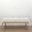 White tablecloth with gold stripes on a dining table set for two.