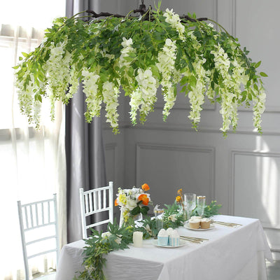 Artificial wisteria chandelier above a beautifully set dining table.