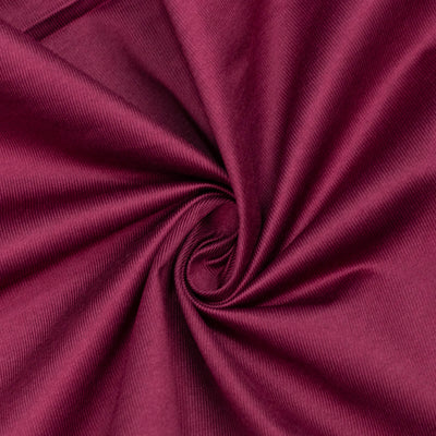 Magenta fabric swirl texture close-up with soft folds