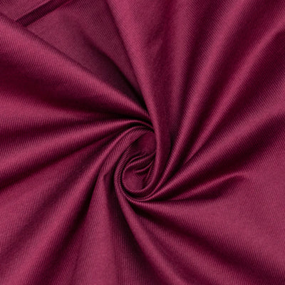 Magenta fabric texture with a swirling fold pattern#whtbkgd