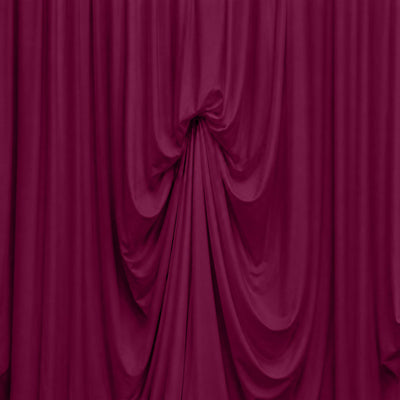 Magenta velvet curtain with dramatic draped folds on stage